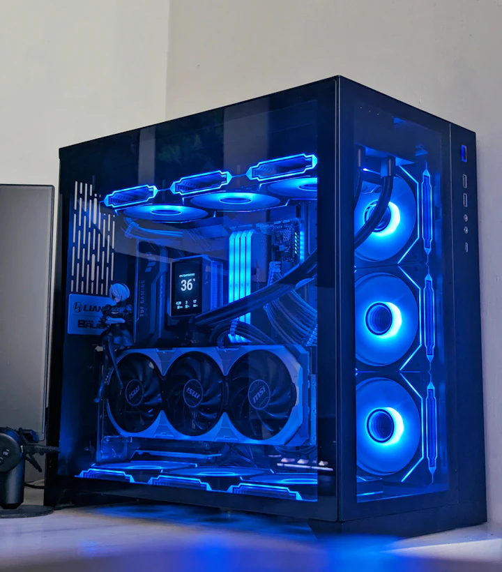Panoramic glass PC case with ice-blue lighting and a large graphics card