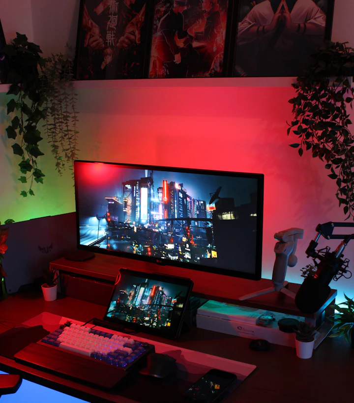 Designer studio desk with red ambient lighting, ultrawide monitor and pen display